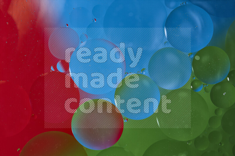 لقطات مقربة لفقاعات من الزيت على سطح الماء باللون الأزرق والأحمر والأخضر