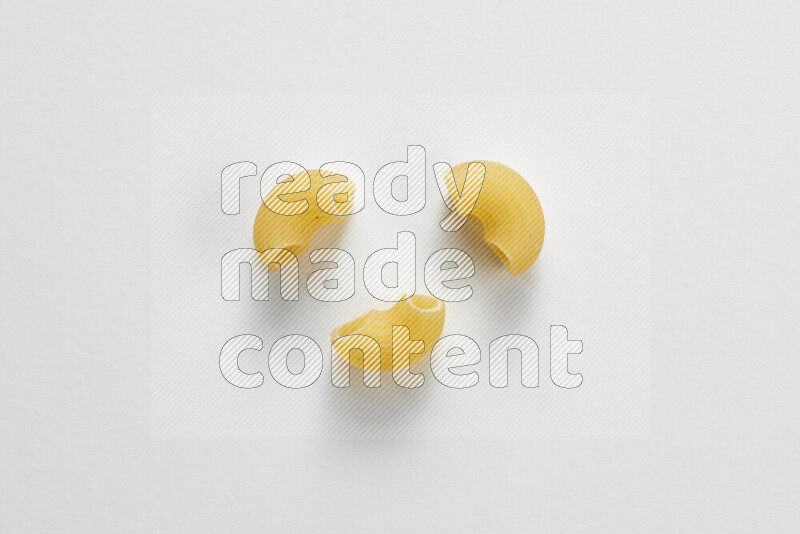 Elbow pasta on white background