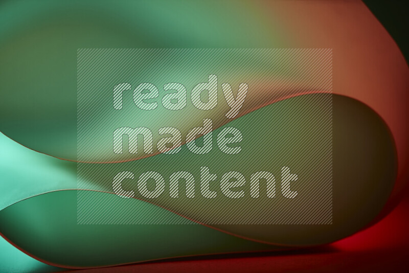 فن تجريدي يعرض منحنيات وتدرجات اللون الأخضر والبرتقالي مكونه بضوء ملون