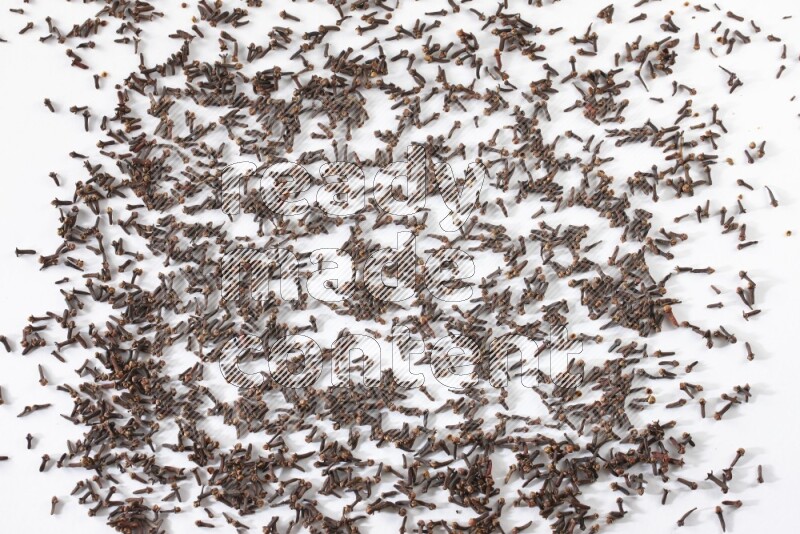 Cloves spread on white flooring