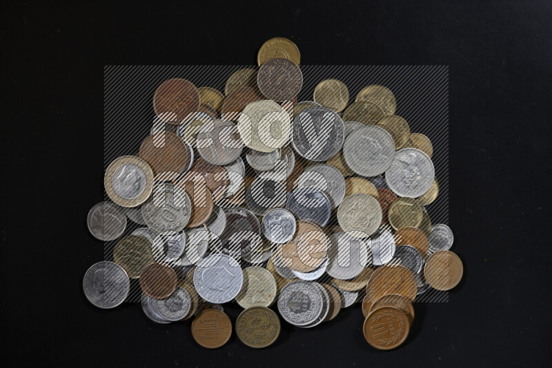 A close-ups of random old coins on black background