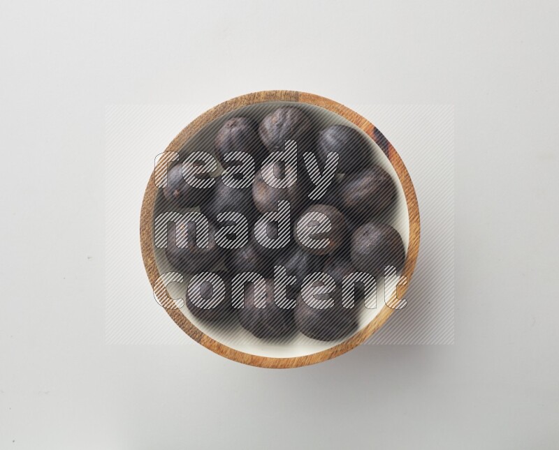 Top-view shot of dried lime (loomi) in a container on white background