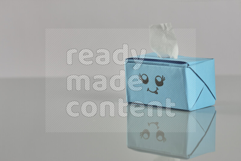Origami tissue box on grey background