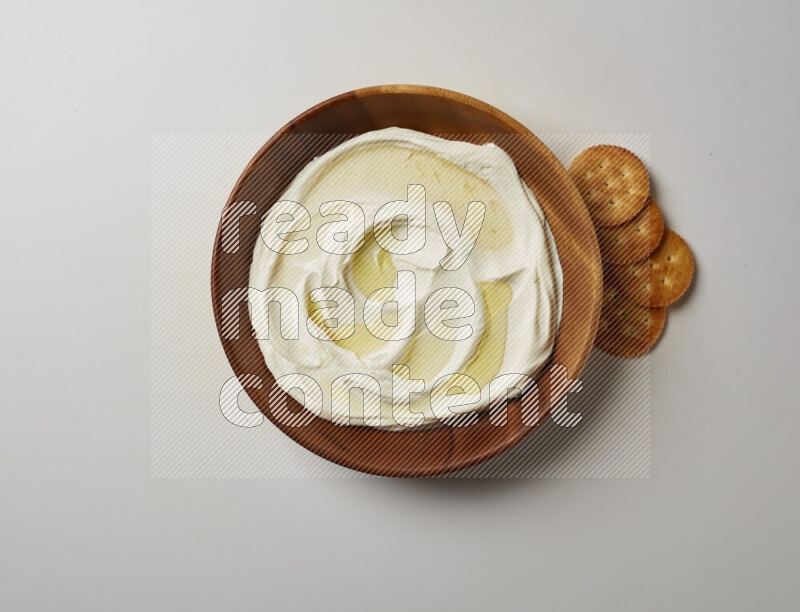 Lebnah garnished with olive oil in a wooden plate on a white background