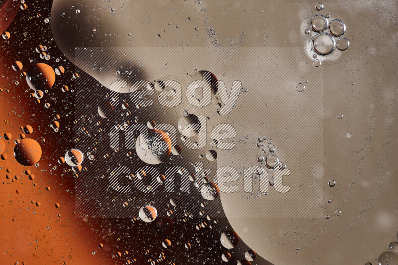 لقطات مقربة لفقاعات من الزيت على سطح الماء باللون البرتقالي والبني