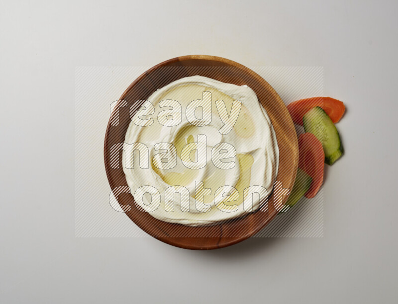 Lebnah garnished with olive oil in a wooden plate on a white background