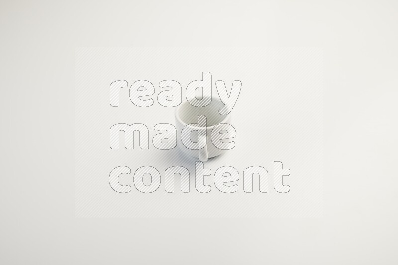 white ceramic cup on white countertop