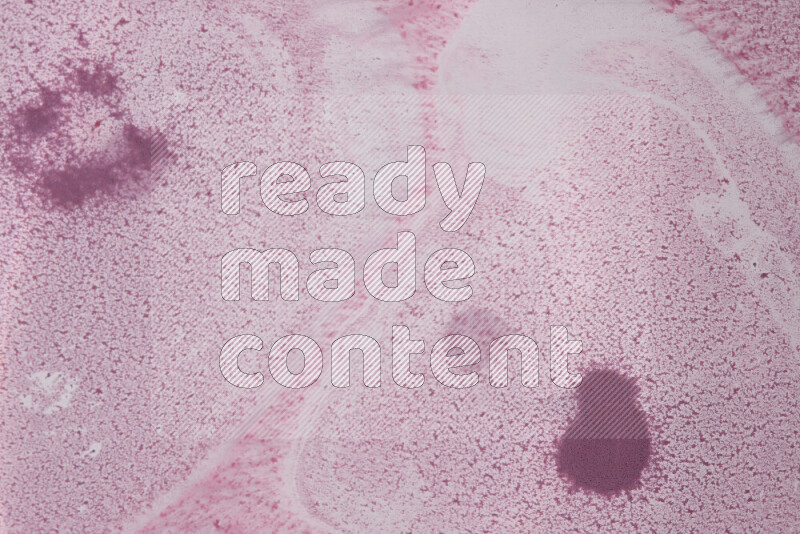 The image captures a dramatic splatter of purple paint over a white backdrop