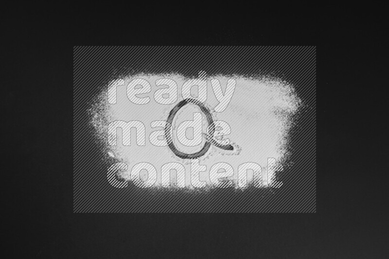 Alphabets written with powder on black background