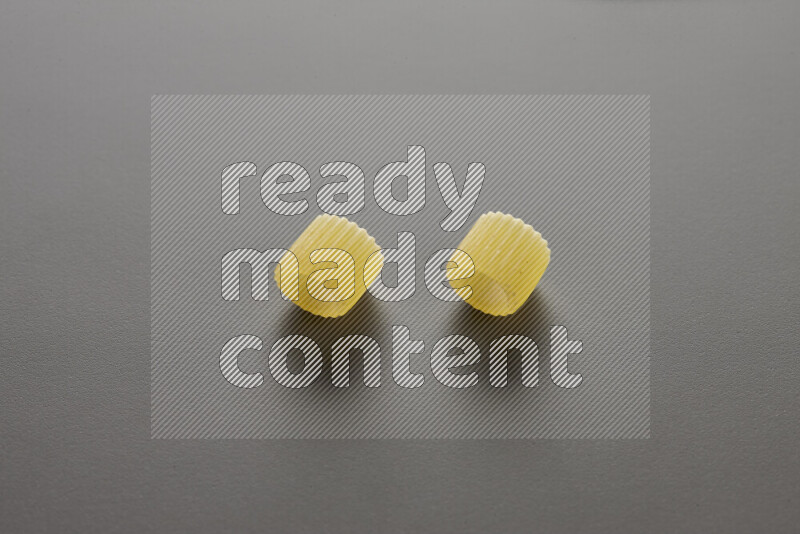 Big rings pasta on grey background