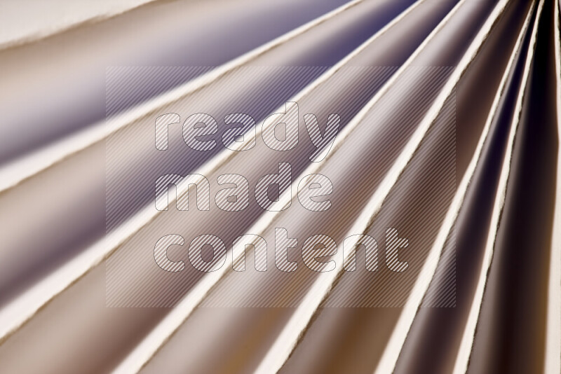 An image presenting an abstract paper pattern of lines in white and gold tones