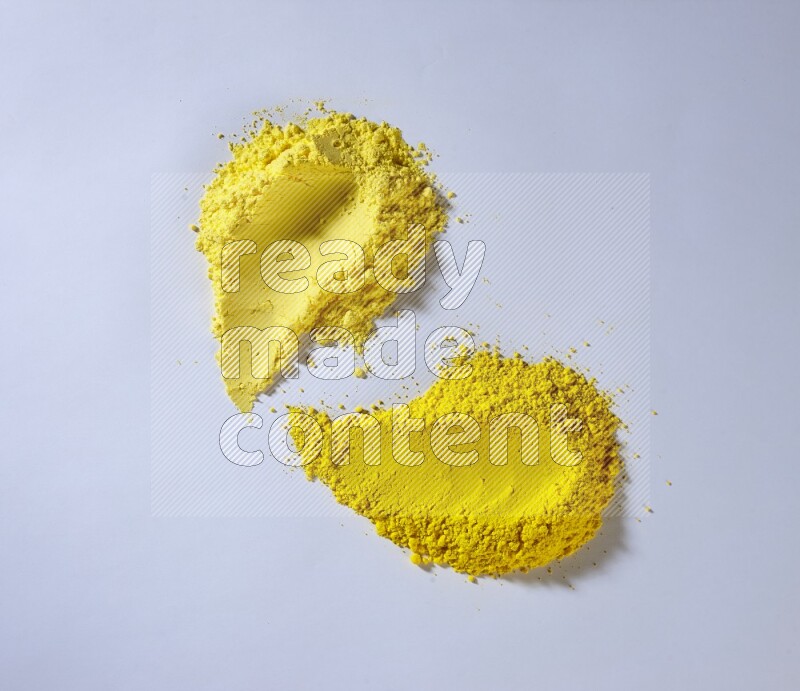 Yellow powder smears on white background
