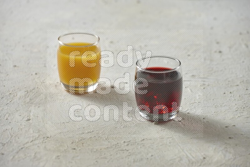 Cold drinks in a glass cup such as water, tamarind, qamar eldin, sobia, milk and hibiscus on textured white background