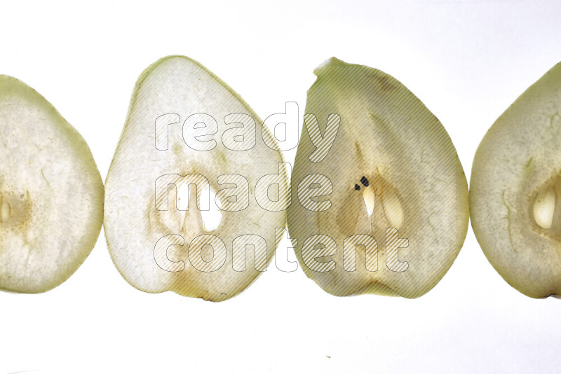 Pear slices on illuminated white background