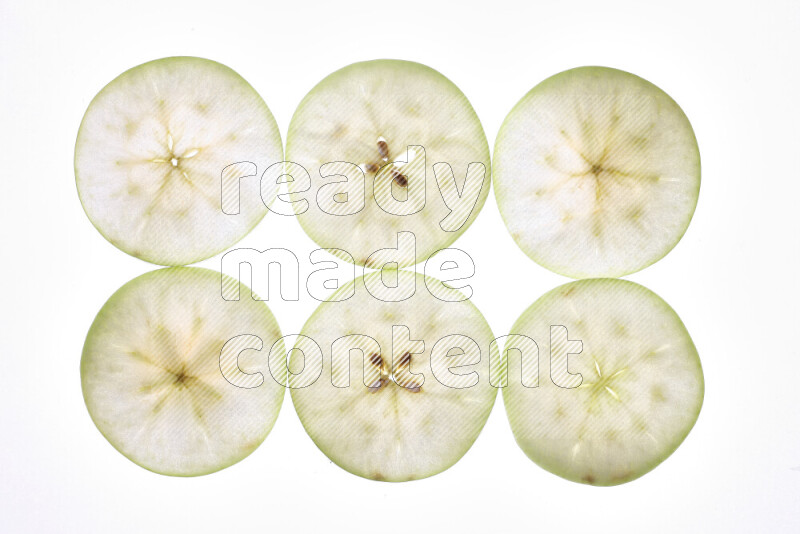 Apple slices on illuminated white background