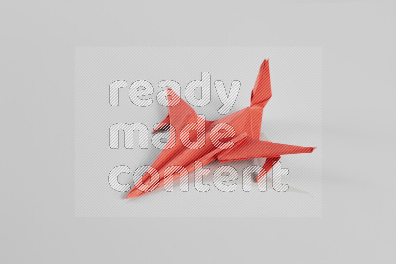 Origami plane on grey background