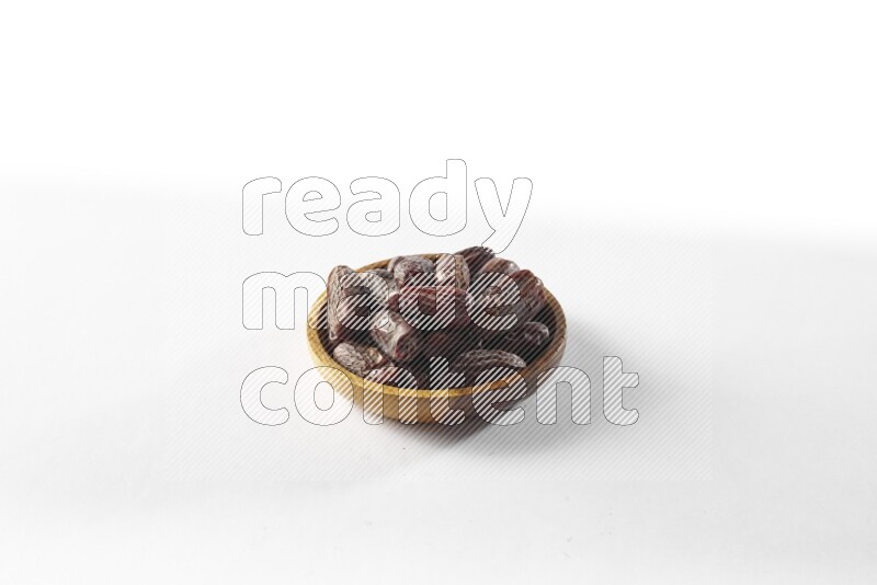 Dates in a wooden bowl on white background