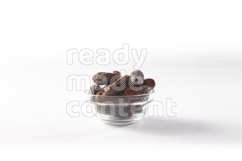 Dates in a glass bowl on white background