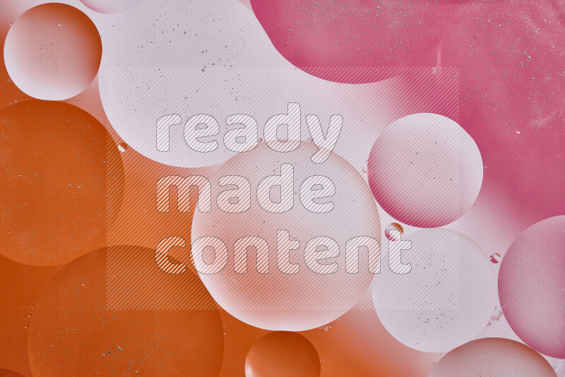 Close-ups of abstract oil bubbles on water surface in shades of white, orange and pink