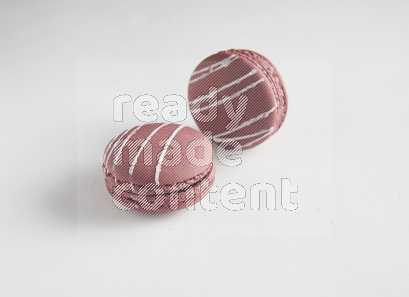 45º Shot of two Red Poppy Flower macarons on white background