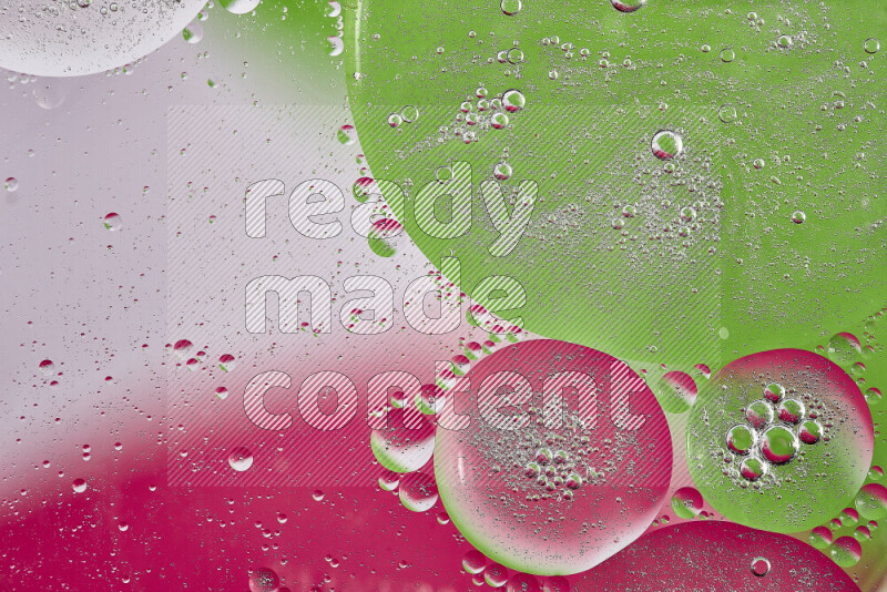 Close-ups of abstract oil bubbles on water surface in shades of pink, green and white