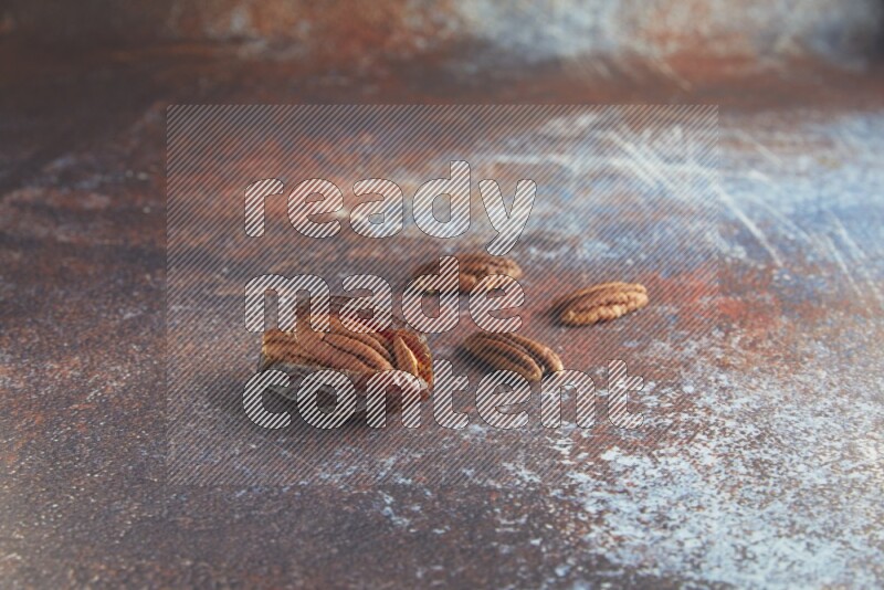 one pecan stuffed madjoul date on a rustic reddish background