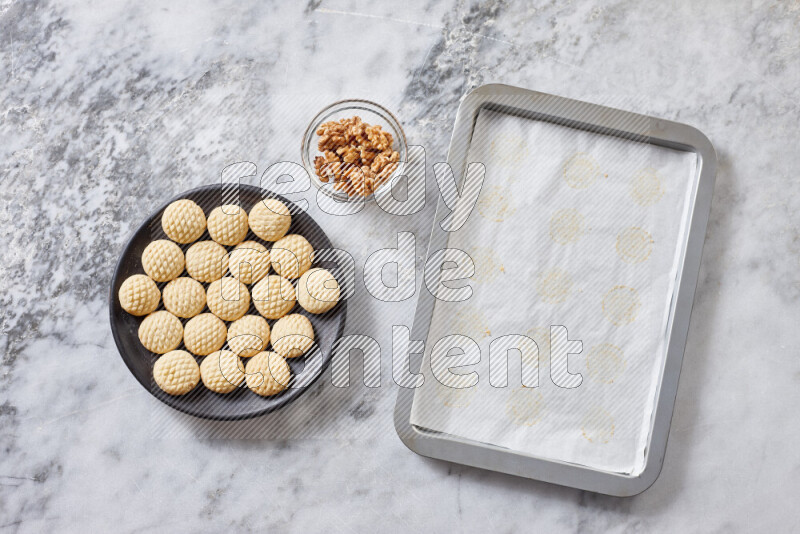 Kahk step by step with its ingredients ghee, sugar, flour, sesame, yeast, water and kahk flavor on grey marble background
