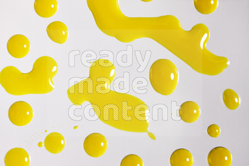 Close-ups of abstract yellow paint droplets on white background