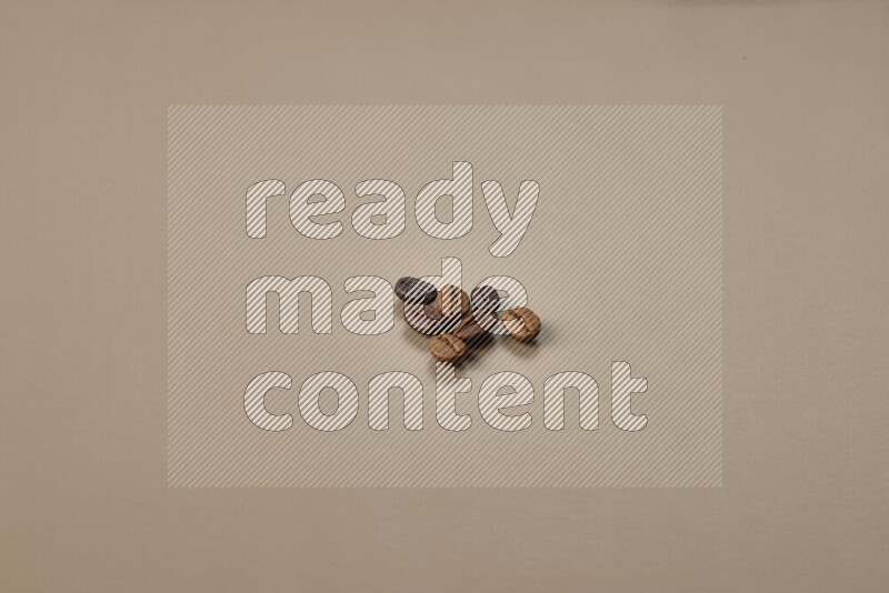 Roasted coffee beans on beige background