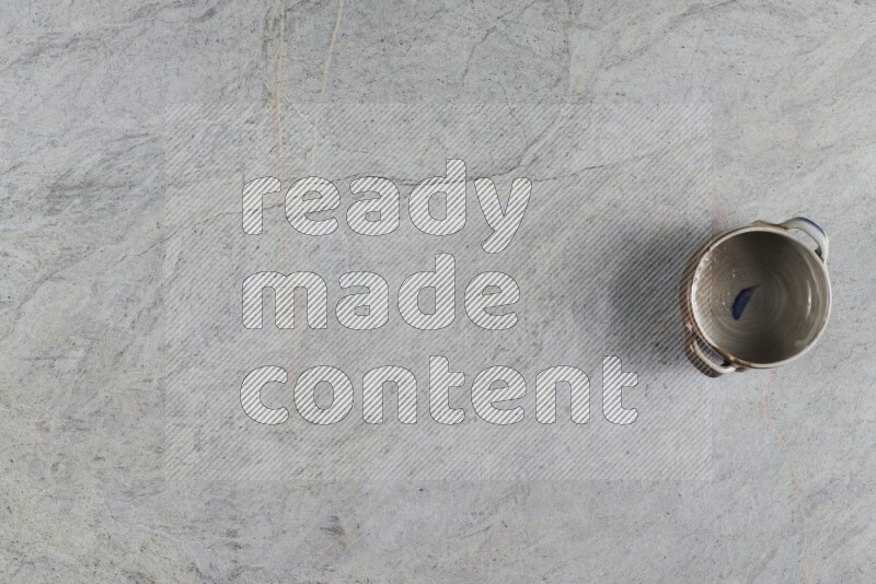 A multicolored pottery Bowl on grey marble background