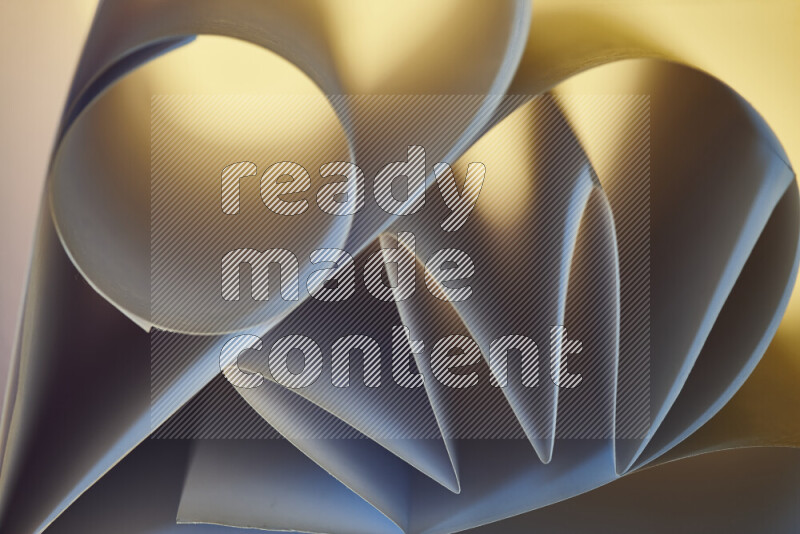 An artistic display of paper folds creating a harmonious blend of geometric shapes, highlighted by soft lighting in blue and warm tones