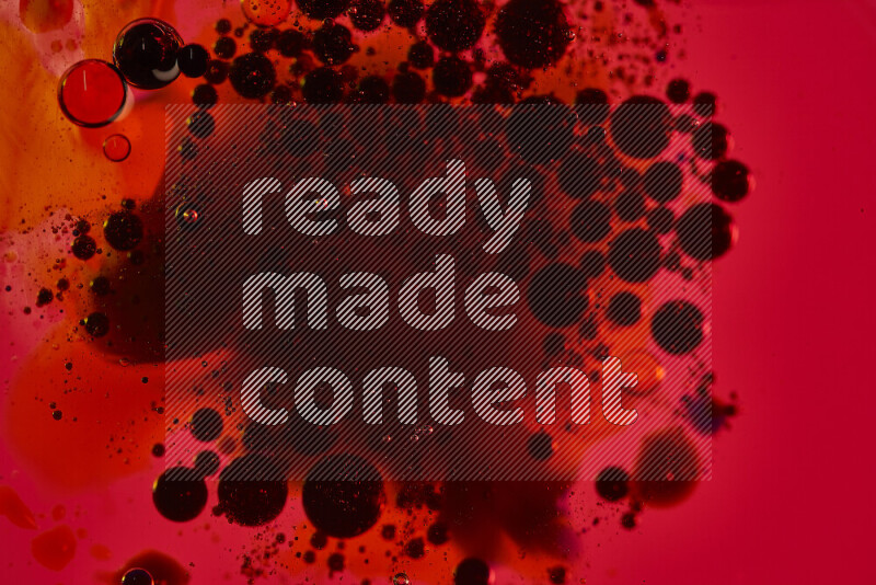 Close-ups of abstract black watercolor drops on oil Surface on red background