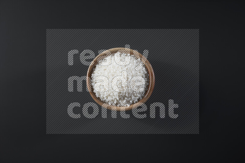White rice in a wooden bowl on grey background