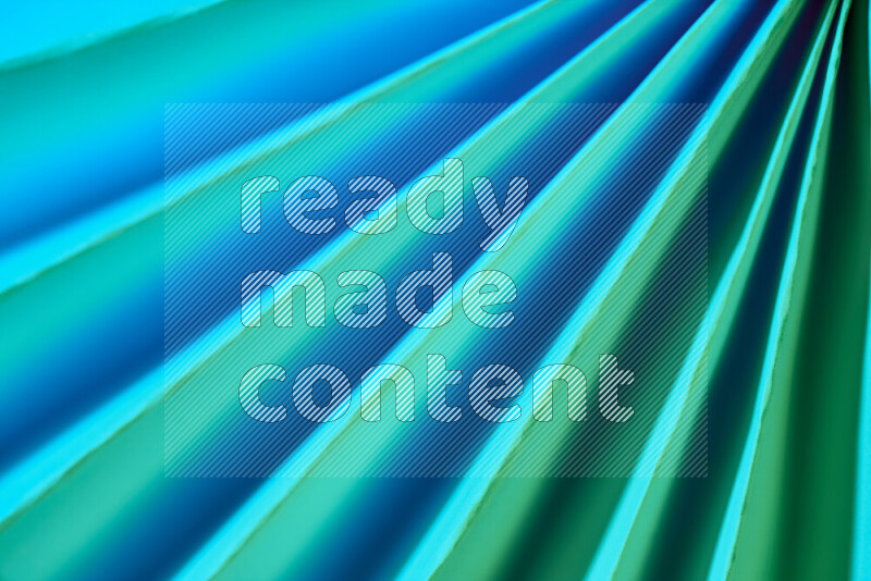 An image presenting an abstract paper pattern of lines in green and blue tones