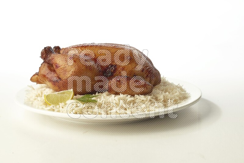 white  basmati Rice with  whole roasted chicken  on a white rounded plate direct on white background