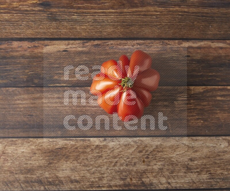 Single topview Heiloom Tomato on a wooden background