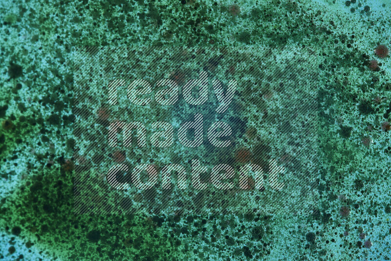 Close-ups of abstract green watercolor drops on oil Surface on green background