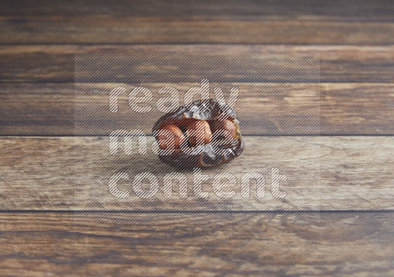 hazelnut stuffed madjoul date on a wooden background