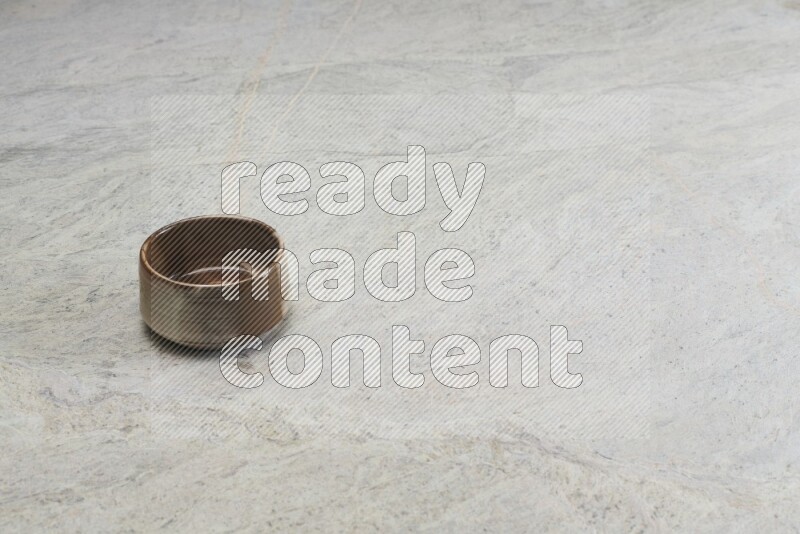 A multicolored pottery bowl on grey marble background