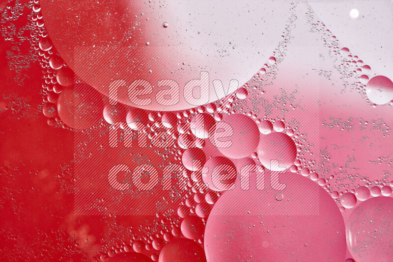 Close-ups of abstract oil bubbles on water surface in shades of white, red and pink