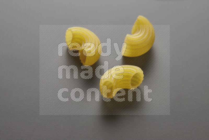 Elbow pasta on grey background