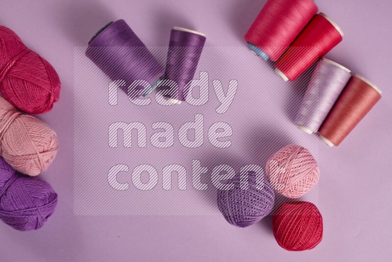 A pink and purple collection of sewing and tailoring tools arranged on a purple background