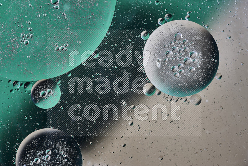 Close-ups of abstract oil bubbles on water surface in shades of green and brown