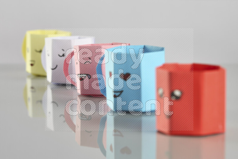 Origami cup on grey background