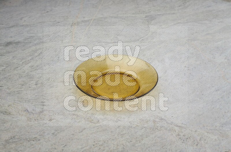 A circular glass plate on grey marble background
