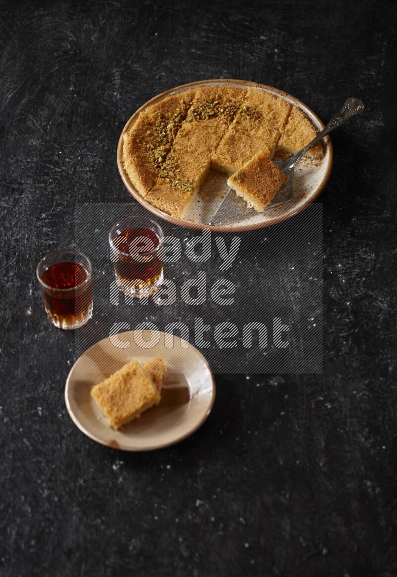 konafa with tea in a dark setup