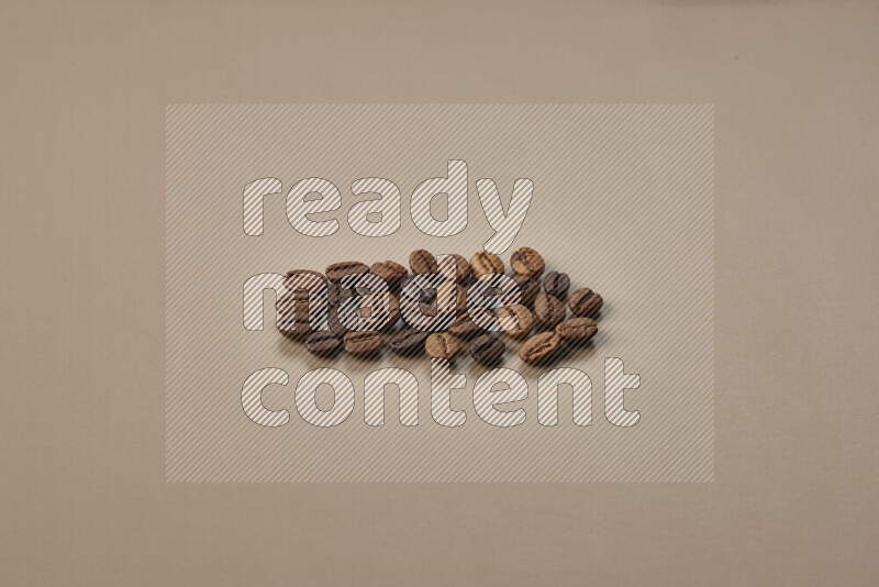 Roasted coffee beans on beige background