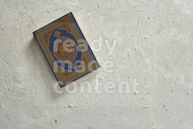 Quran with a prayer beads on white background