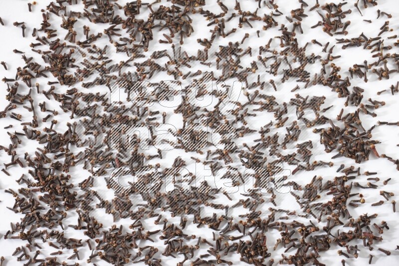 Cloves spread on white flooring