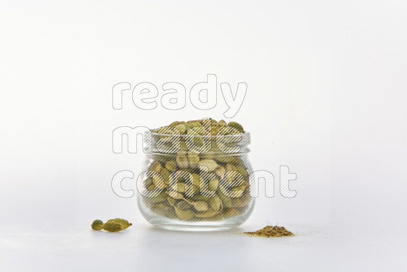 Cardamon in a container on white background